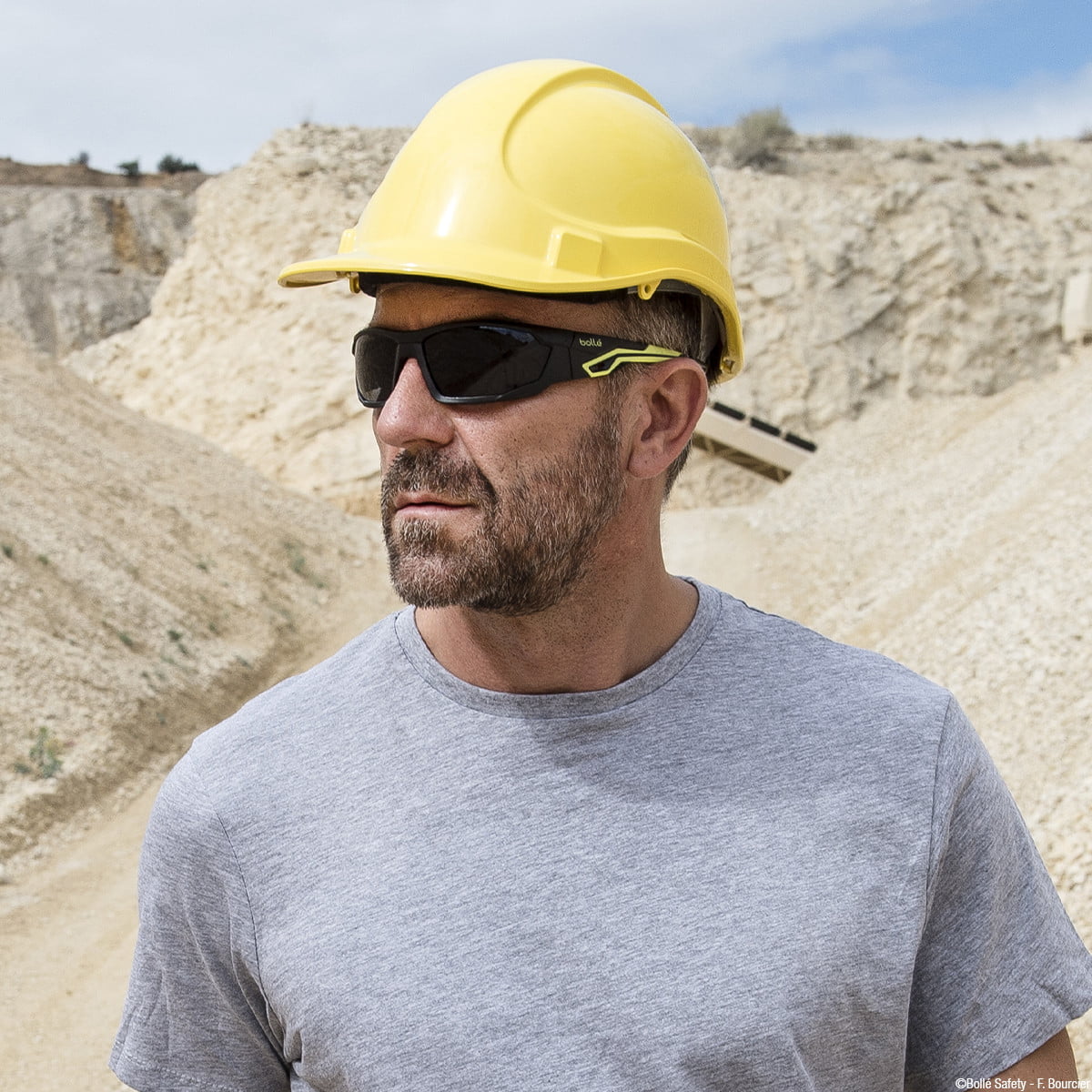 A man wearing workwear and safety boots.